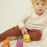 A child playing with the Oli & Carol 100% Natural Rubber Cars