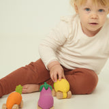 A child playing with the Oli & Carol 100% Natural Rubber Cars