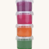 A vertical stack of the Neogrun organic play dough showing the green, orange pink and purple play dough in plastic tubs