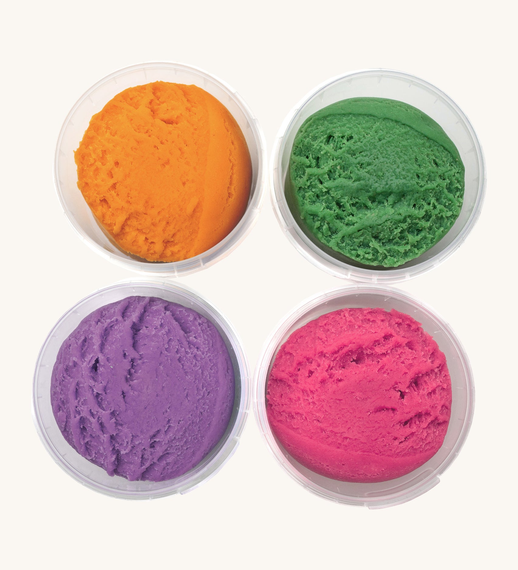 A top down view of the Neogrun 4 pack organic play dough. Showing the consistency of the 4 coloured play dough inside the plastic tubs