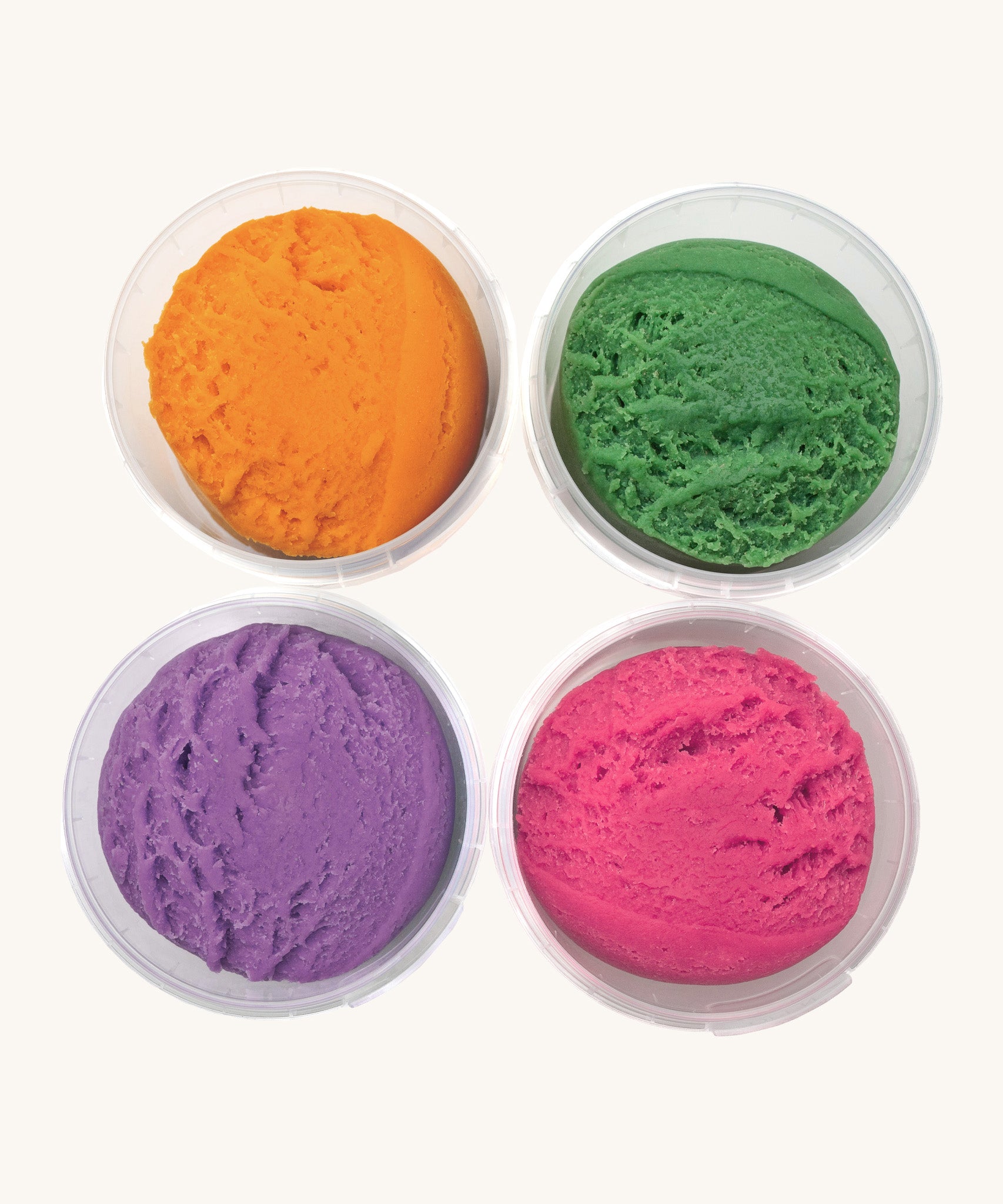 A top down view of the Neogrun 4 pack organic play dough. Showing the consistency of the 4 coloured play dough inside the plastic tubs