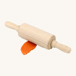 Neogrun wooden rolling pin on top of the orange organic play dough. Features handles on each side for easy handling