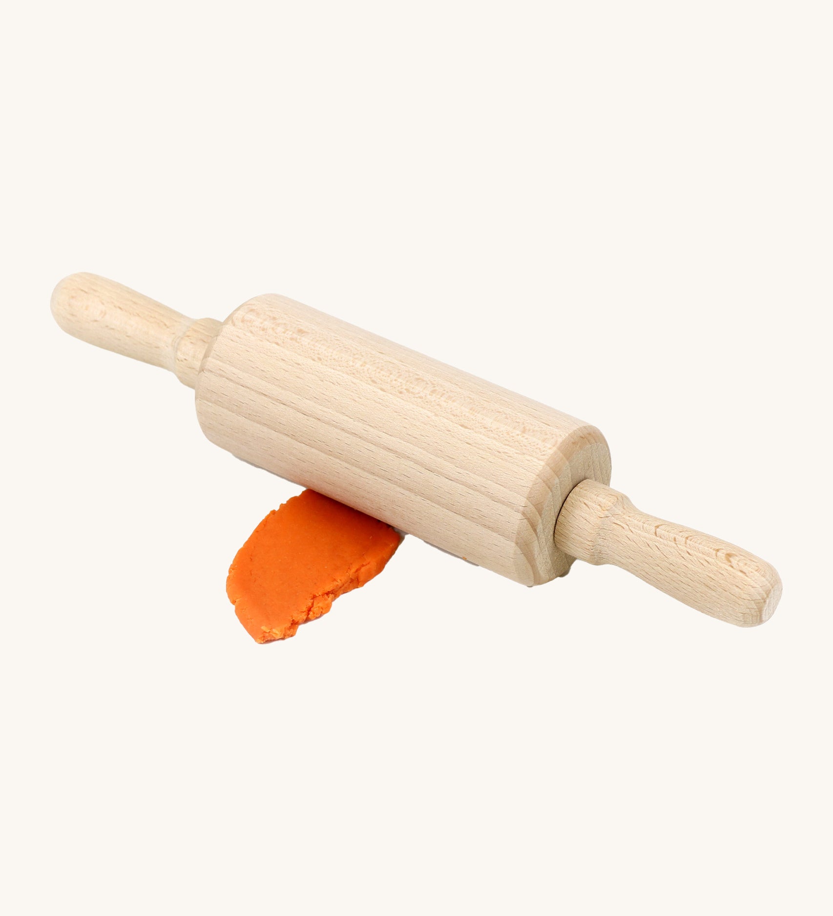 Neogrun wooden rolling pin on top of the orange organic play dough. Features handles on each side for easy handling