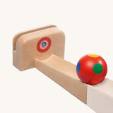 The Nic Cubio Ball Track Outlet with Ringing Sound bell is a wooden attachment that can be used as an end piece on the wooden Nic ball runs. The ball shown is not included with this outlet.