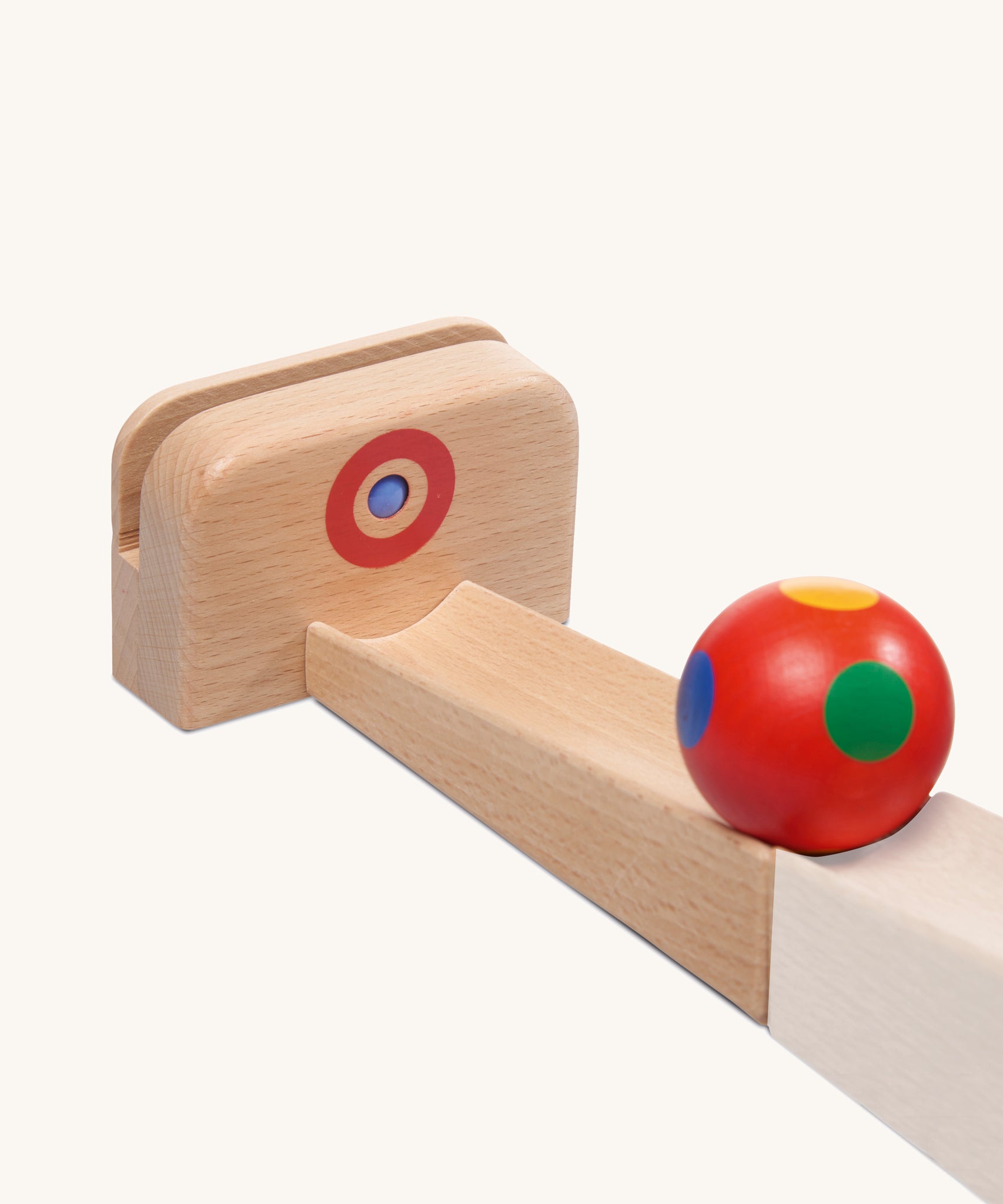 The Nic Cubio Ball Track Outlet with Ringing Sound bell is a wooden attachment that can be used as an end piece on the wooden Nic ball runs. The ball shown is not included with this outlet.