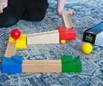 The Nic Cubio Wooden Marble Run Starter Set shown set up on a blue and white patterned rug. 
