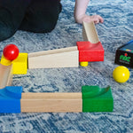 The Nic Cubio Wooden Marble Run Starter Set shown set up on a blue and white patterned rug. 