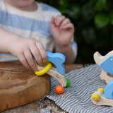 Child playing with the Nic dolphin wooden baby grasping toy.