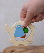 Nic elephant grasper wooden baby toy in a child's hand.
