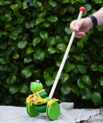 Nic Toys frog king push along toy. Green frog with yellow felt details and gold bell. 