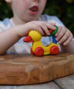 Child playing with the Nic Toys wooden yellow grip duck baby toy.