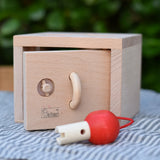 Front of the Nic lock a bloc wooden shape sorter toy with the door slightly ajar.