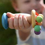 Nic organic carousel rattle spinning baby grasping toy in a child's hand.
