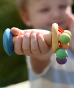 Nic organic carousel rattle spinning baby grasping toy in a child's hand.