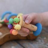 Nic organic carousel rattle spinning baby grasping toy in a child's hands.
