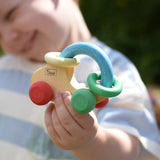 Nic organic grip car wooden baby toy in a child's hand.