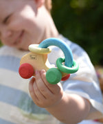 Nic organic grip car wooden baby toy in a child's hand.