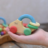 Nic organic grip car wooden baby toy placed on a child's hand.