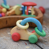 Nic organic grip car wooden baby toy placed on a wooden surface.