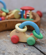 Nic organic grip car wooden baby toy placed on a wooden surface.