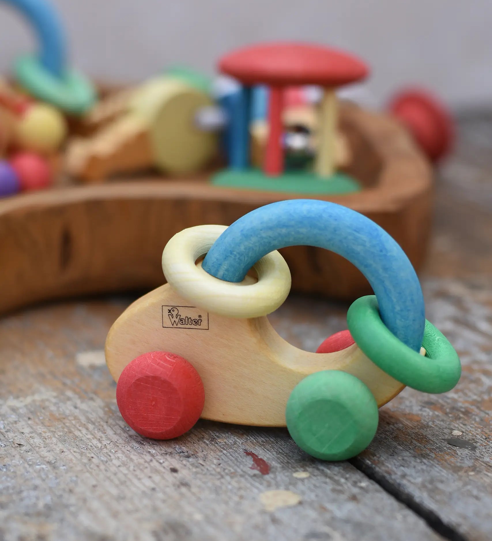 Nic organic grip car wooden baby toy placed on a wooden surface.