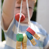 Nic organic wooden grasping keyring set in a child's hand. 
