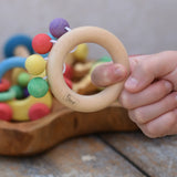 Nic organic teething ring wooden baby toy shown in a hand.