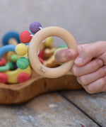 Nic organic teething ring wooden baby toy shown in a hand.