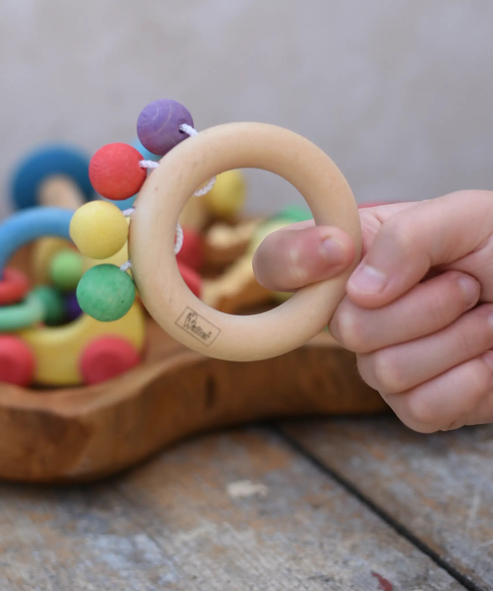 Nic organic teething ring wooden baby toy shown in a hand.