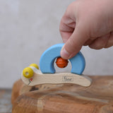 Nic snail baby grasping toy in a child's hand.