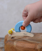 Nic snail baby grasping toy in a child's hand.