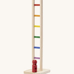 Nic Toys wooden colourful climbing ladder. A tumbling style toy with multicoloured ladder rungs and a red peg doll.