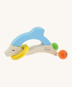 Nic Toys wooden dolphin rattle, features a yellow ring around the body and 2 grasper  balls representing the tail