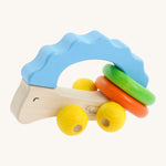 Nic Toys wooden hedgehog grasper. Features yellow grasper balls representing the feet with green and orange rings around it's body for rattling 