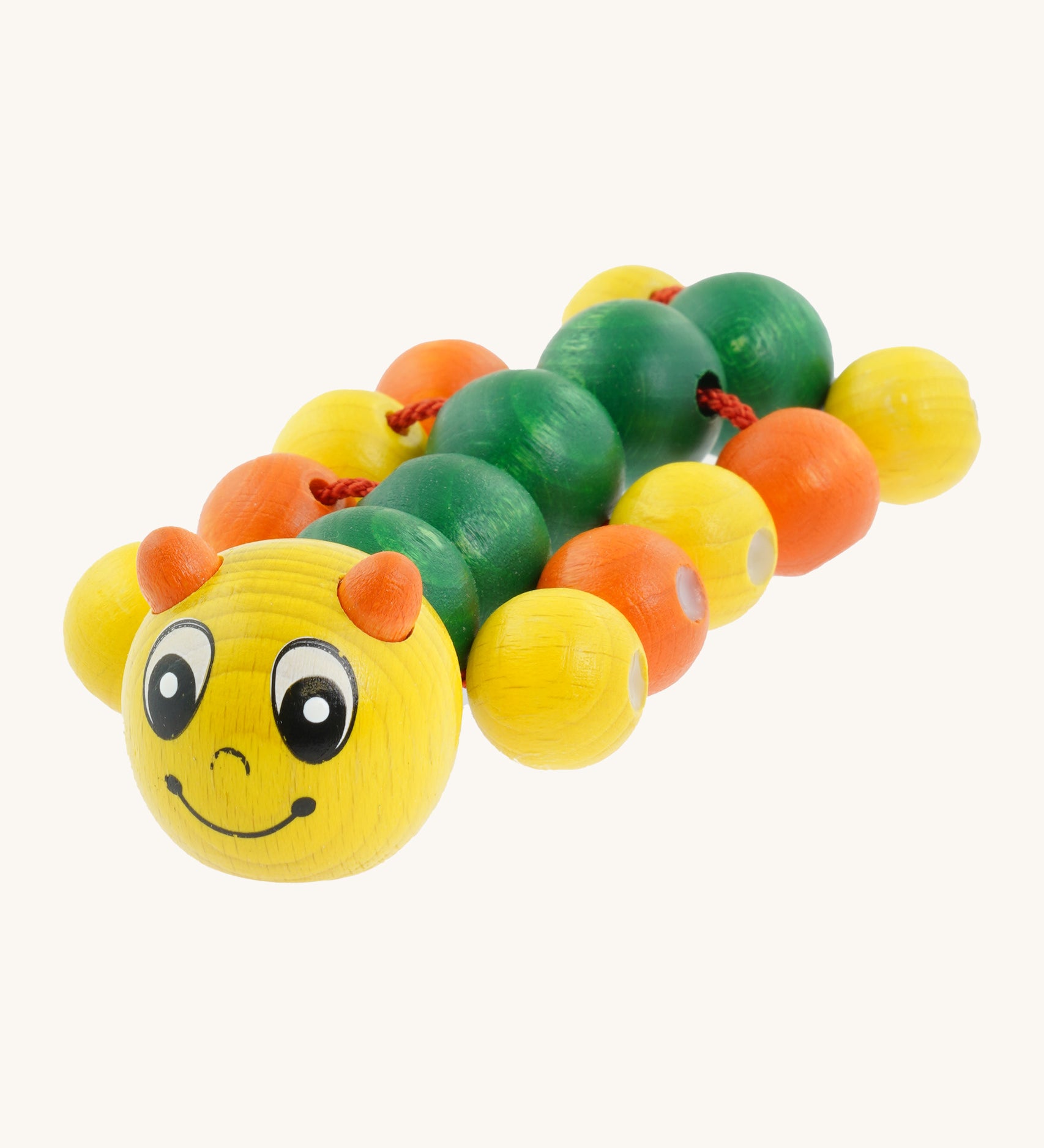 Nic Toys wooden molly the caterpillar grasping toy. Features a yellow and green body with grasping beads representing the feet.