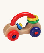 Nic Toys wooden first car. A wooden vehicle with a red handle for easy grasping with green and yellow rings that can be threaded through. Feature bright red and blue wheels and a blue and yellow steeling wheel