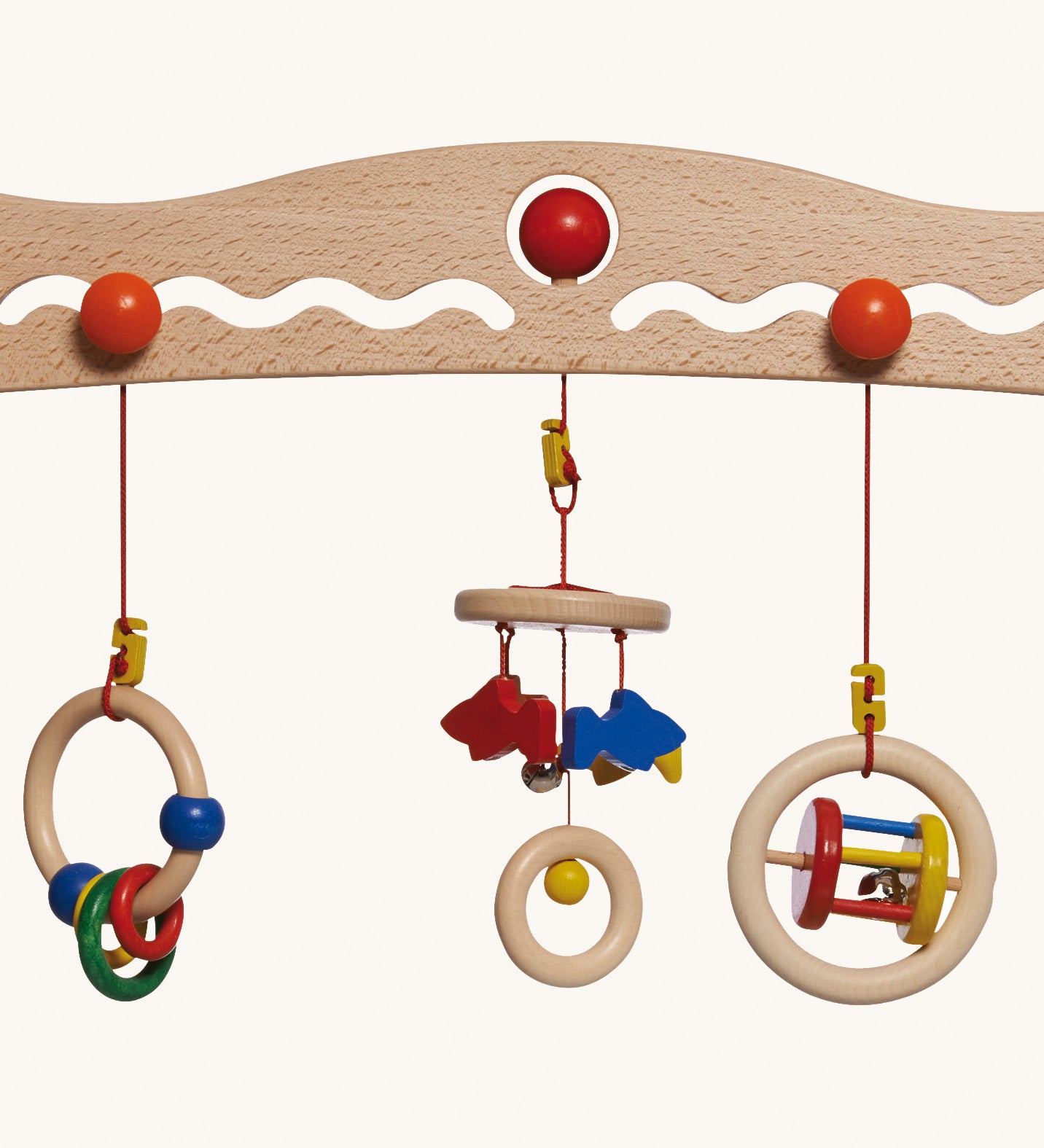 A close up of the 3 grasping toys attached the the Nic Toys wooden baby trainer. Graspers are a mix of rattles and  can be swapped over or taken off 