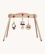 A Nic Toys wooden baby trainer available at Babipur. Features 3 grasping toys that can be swapped over  and hangs above when a baby is lying underneath