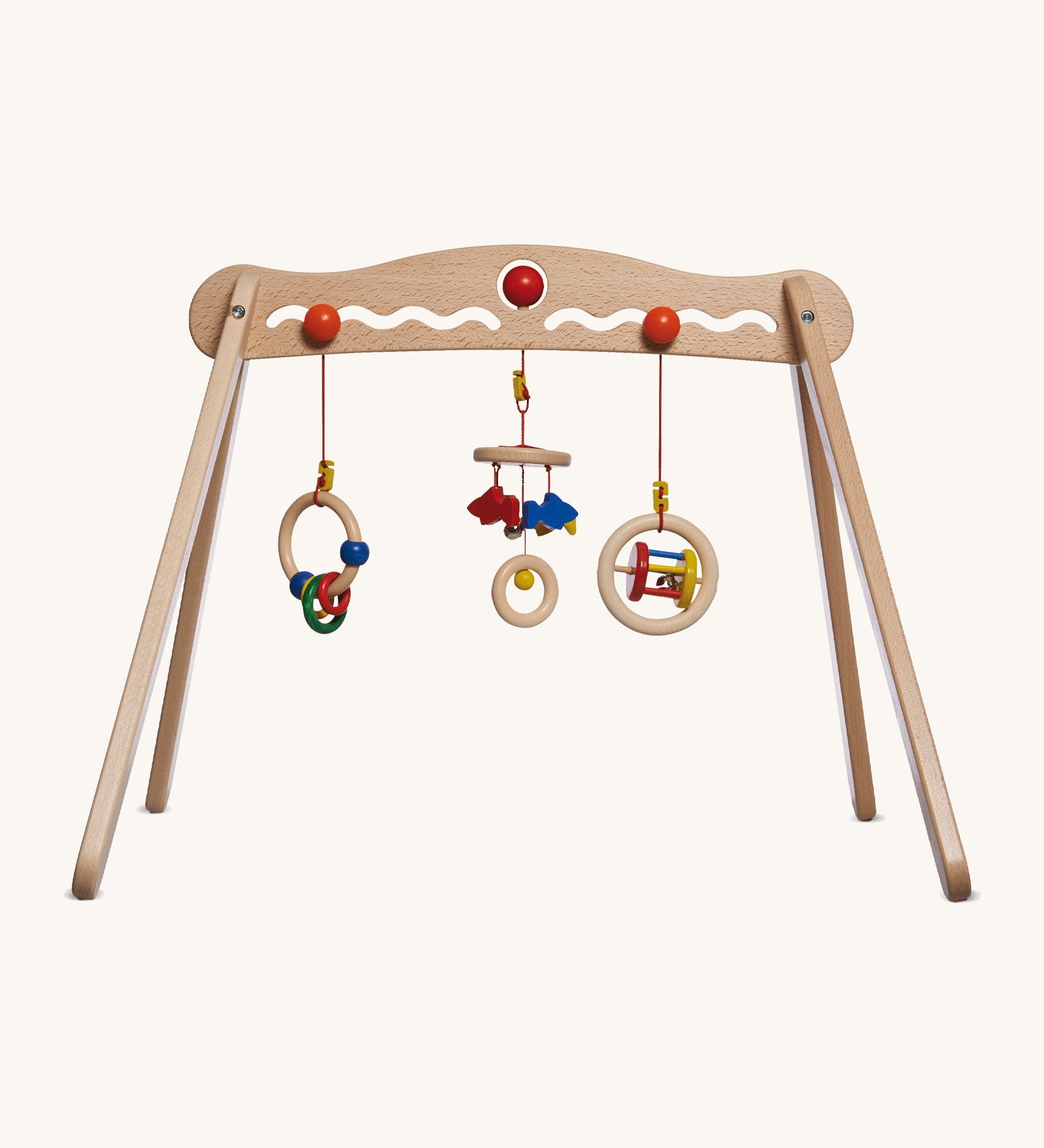A Nic Toys wooden baby trainer available at Babipur. Features 3 grasping toys that can be swapped over  and hangs above when a baby is lying underneath