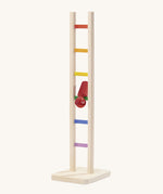 Nic Toys wooden colourful climbing ladder in play showing the red peg doll tumbling down the ladder.