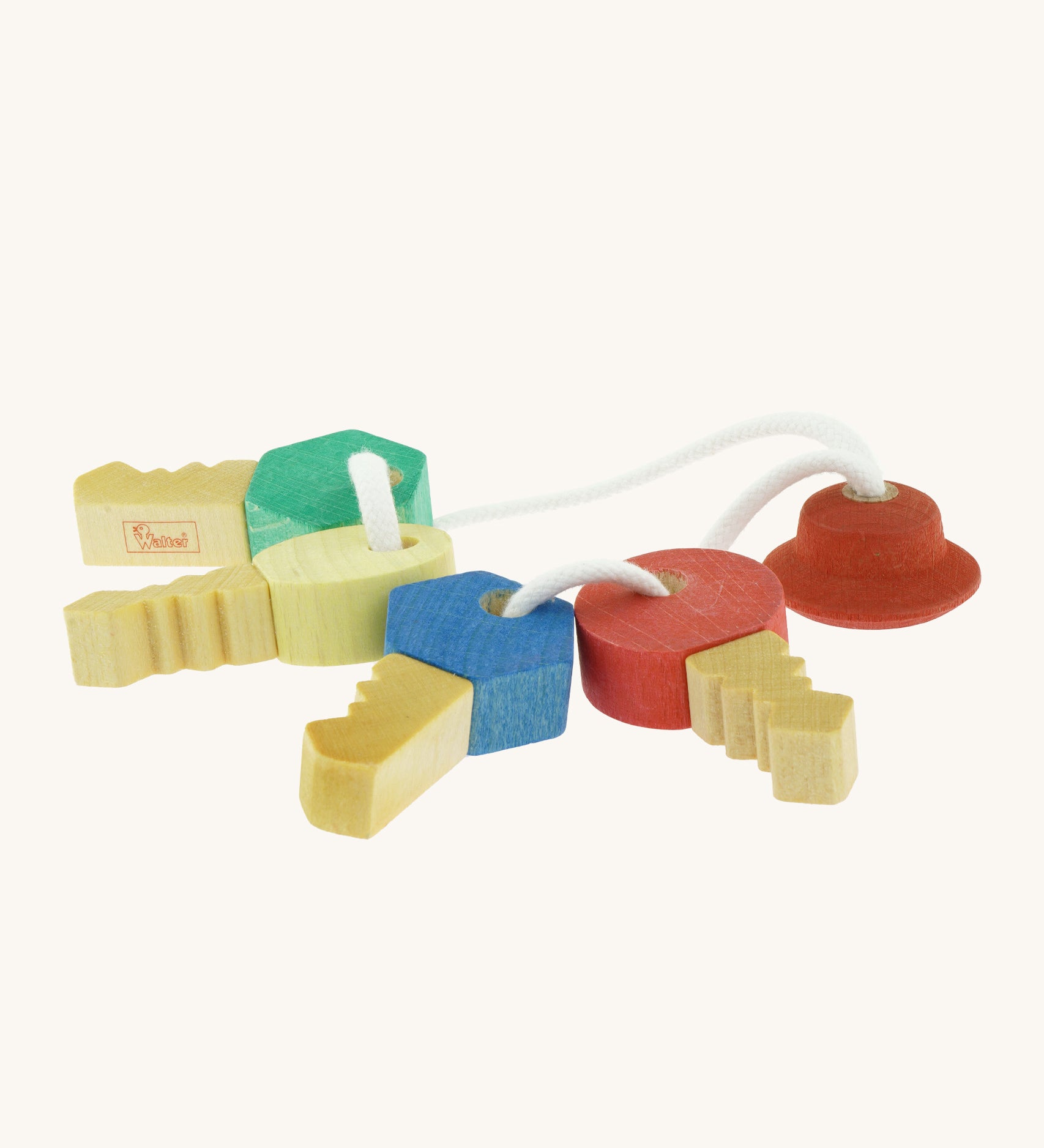 Nic Toys wooden grasping keyring set available at Babipur. A set of 4 handmade keys with different shaped fobs attached on white string.