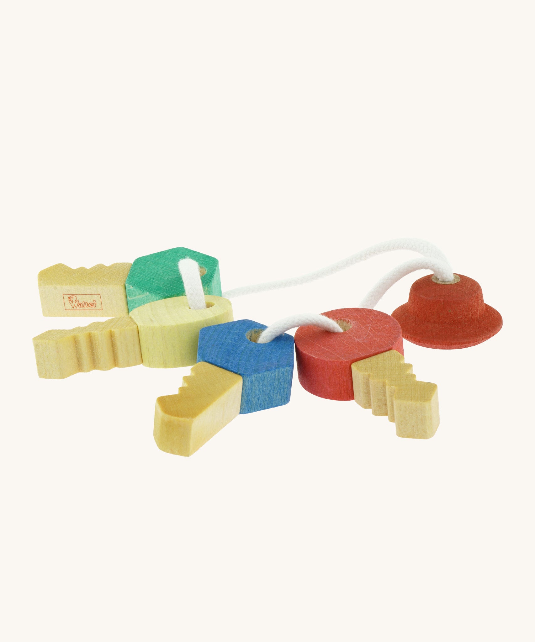Nic Toys wooden grasping keyring set available at Babipur. A set of 4 handmade keys with different shaped fobs attached on white string.