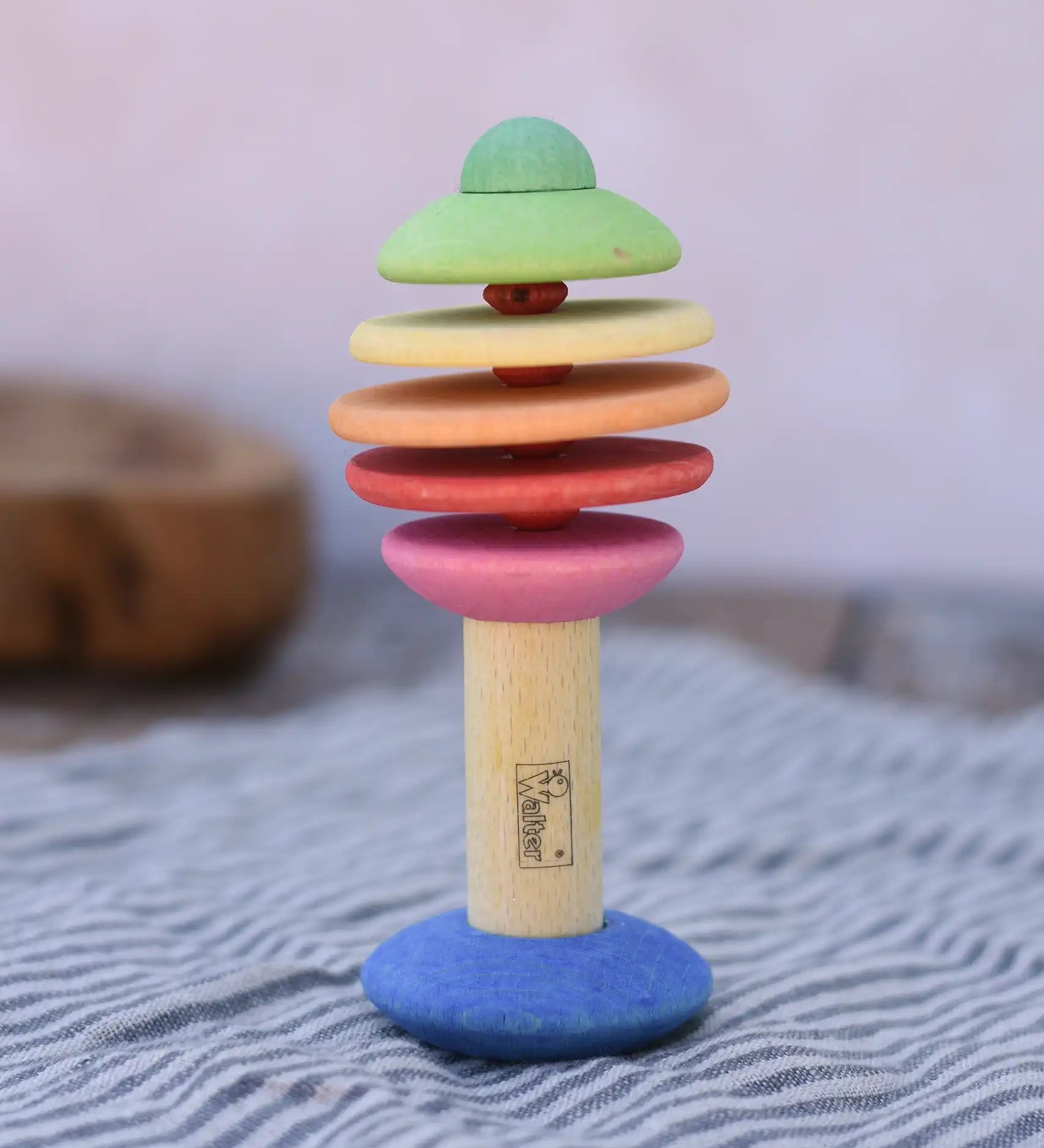 Nic Toys wooden rattling tree baby toy. Coloured disks for making a noise and a wooden handle for grip.