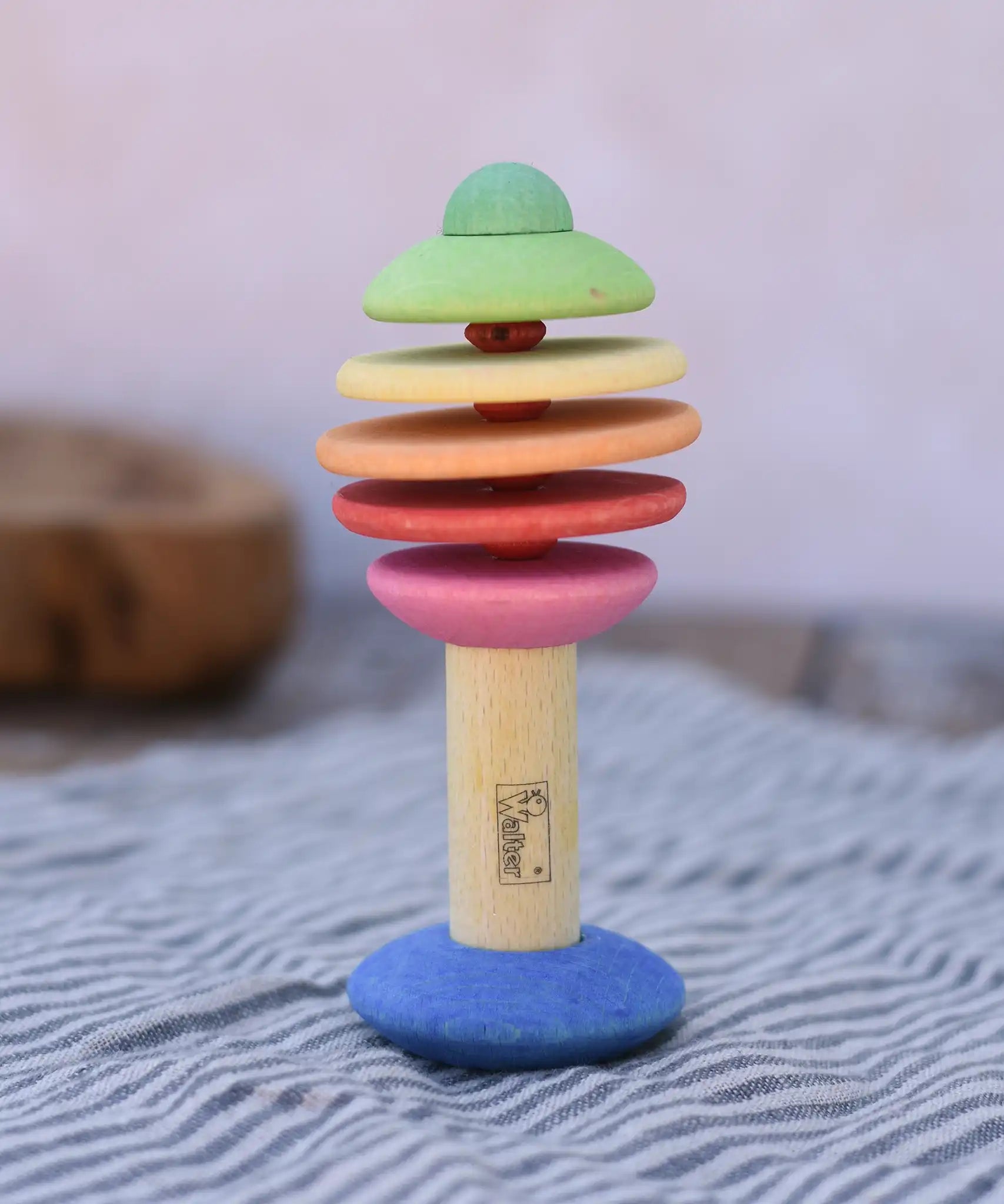Nic Toys wooden rattling tree baby toy. Coloured disks for making a noise and a wooden handle for grip.