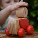 Child pwtting the Nic waggle duck pull along wooden toy.