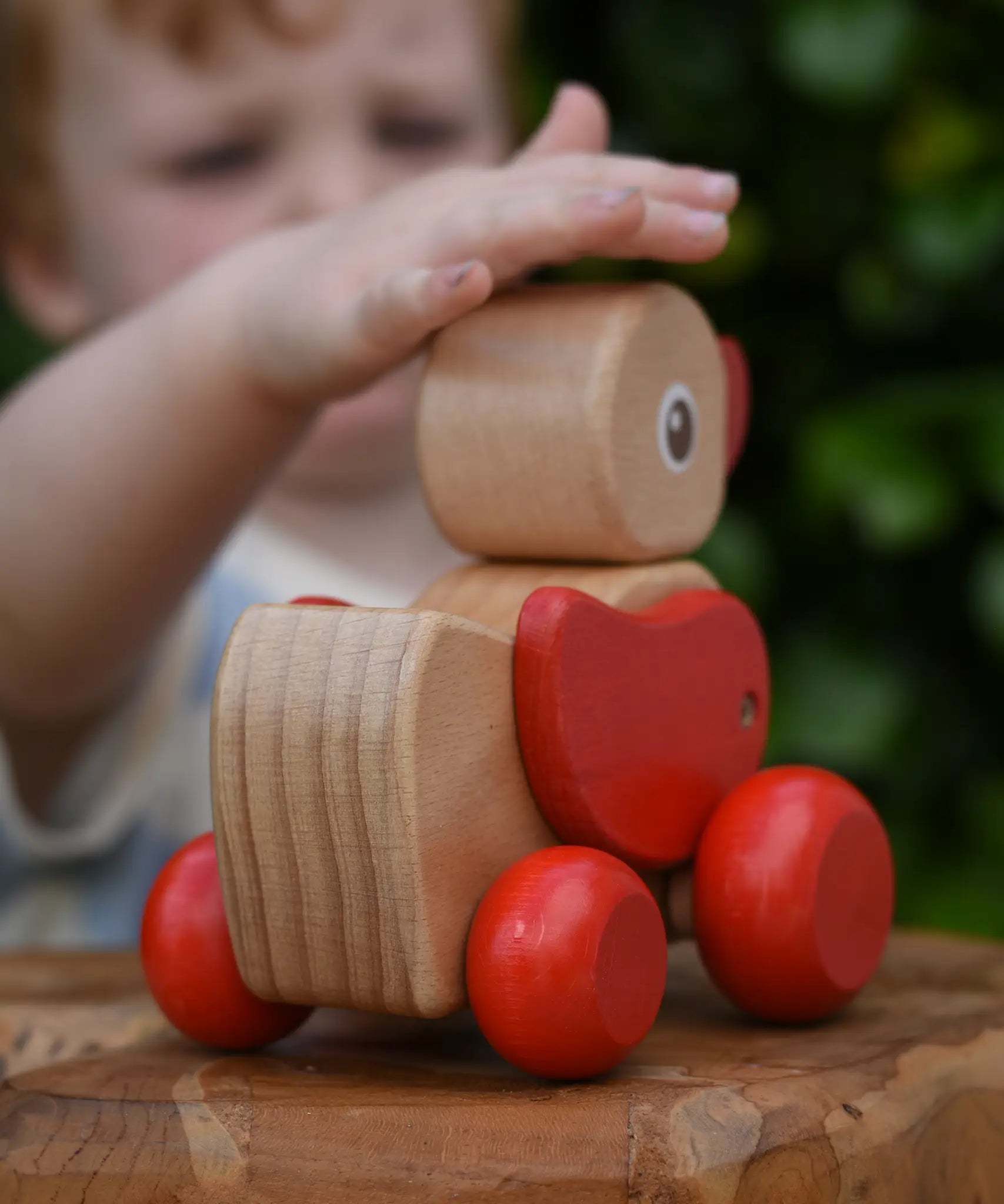 Child pwtting the Nic waggle duck pull along wooden toy.