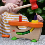 Child playing with the Nic wooden pounding bench hammering toy.