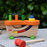 Nic wooden pounding bench hammering toy placed on a table outdoors.