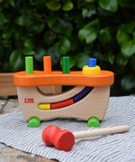 Nic wooden pounding bench hammering toy placed on a table outdoors.