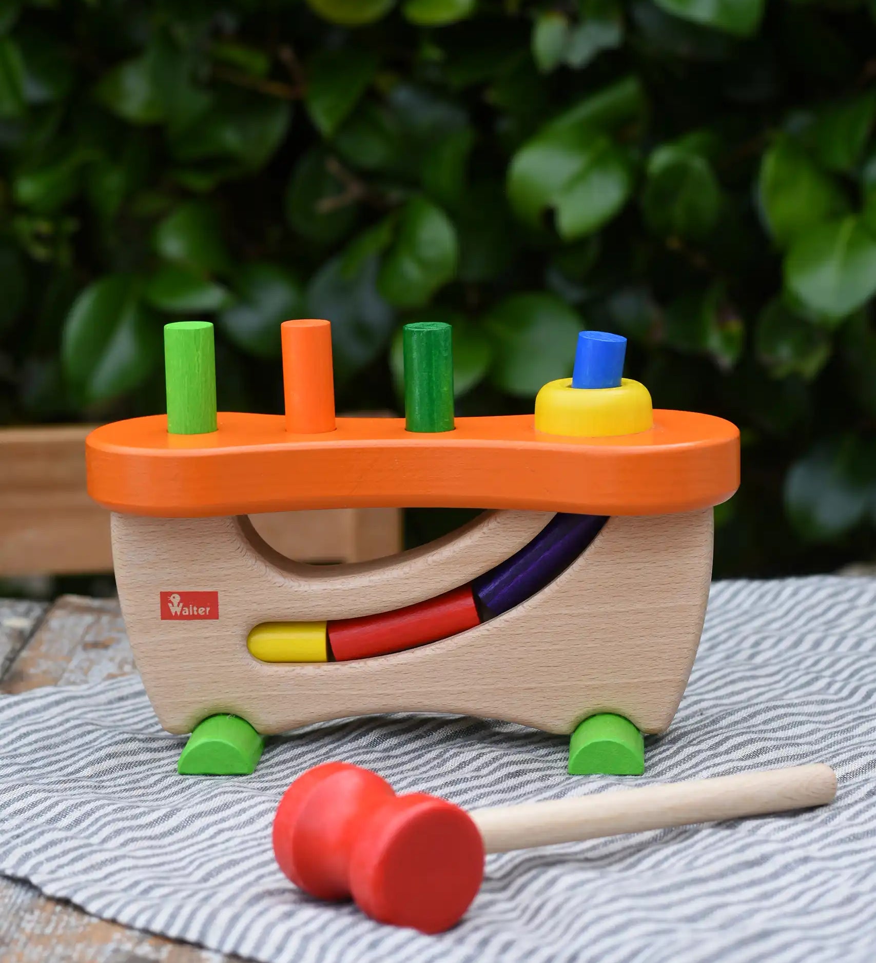 Nic wooden pounding bench hammering toy placed on a table outdoors.